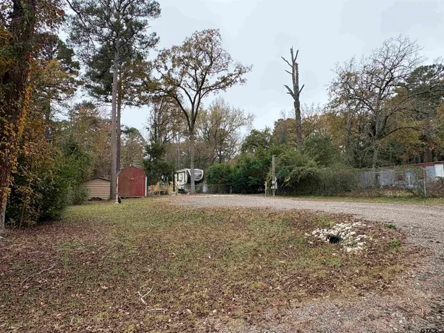 a backyard of a house with a trees