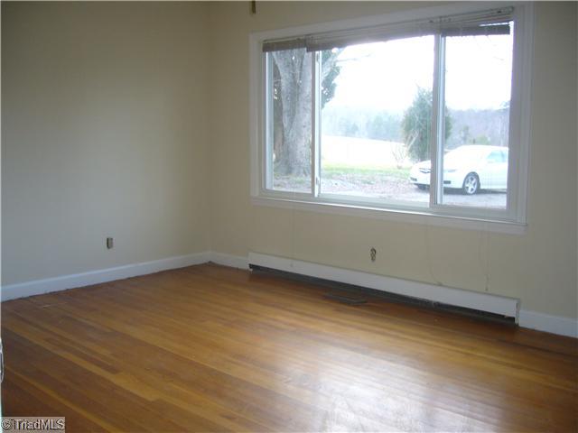 Living Room. The living room has a large picture window overlooking the front yard and includes natural hardwood flooring and a ceiling fan. The entire interior of the home is freshly painted and many of the light fixtures have been updated.