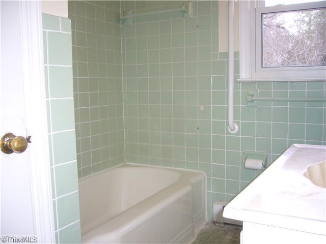 Other. The bathroom is full ceramic tile surround and flooring.  The bathroom includes a vanity, marble sink and a linen closet.