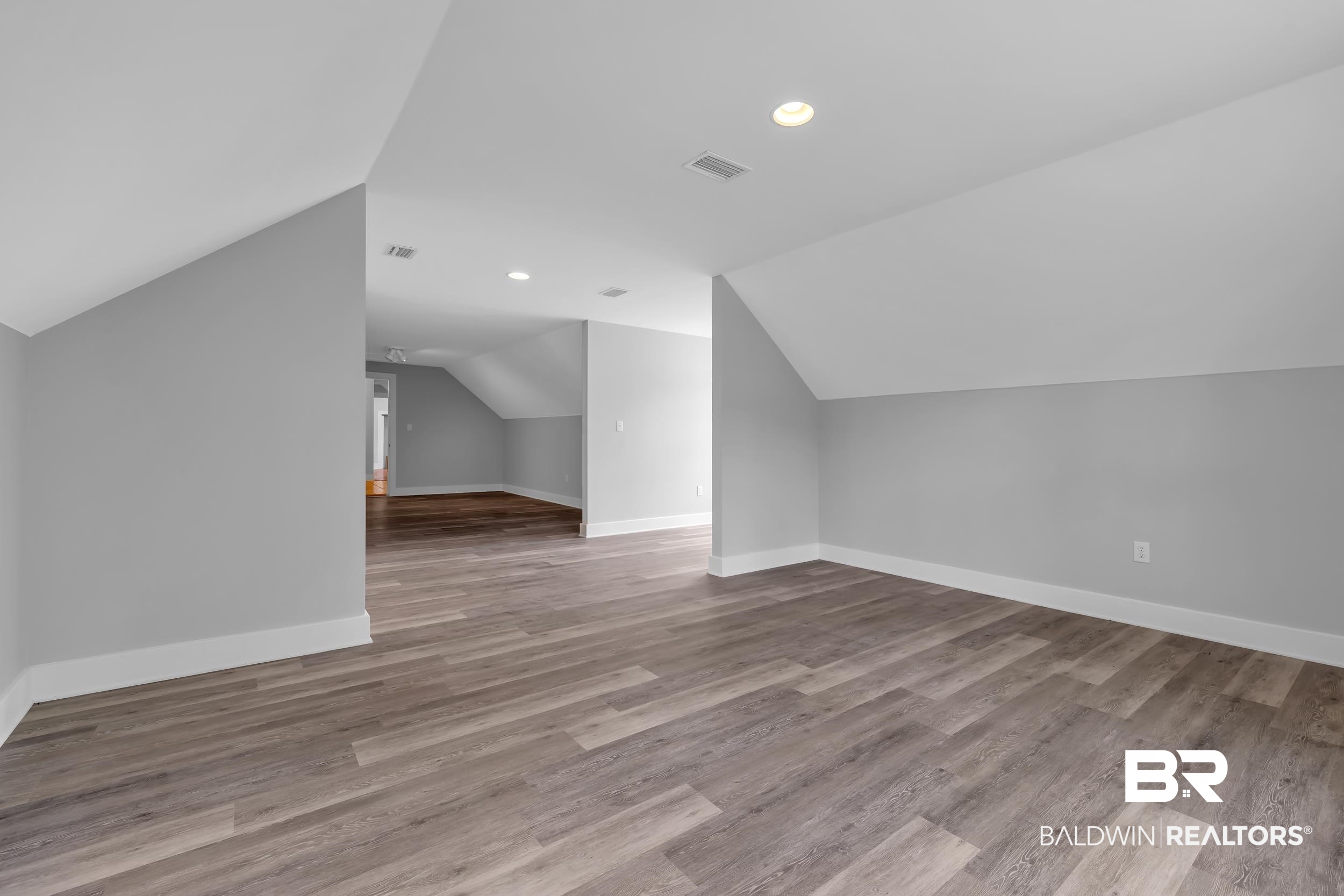 43199 Pine Grove Road Bay Minette, AL 36507 - Photo 65 of 71 Attic space featuring wood-finish flooring, light gray walls, white trim, and recessed lighting