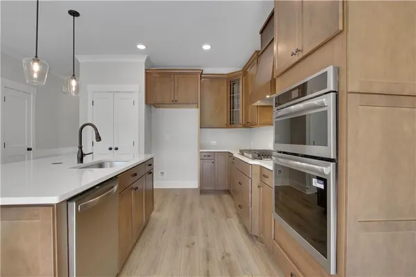 a kitchen with a sink stainless steel appliances and cabinets