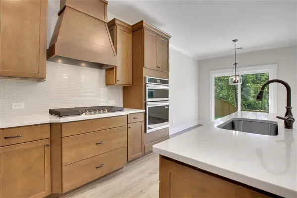 a kitchen with stainless steel appliances a sink stove and refrigerator