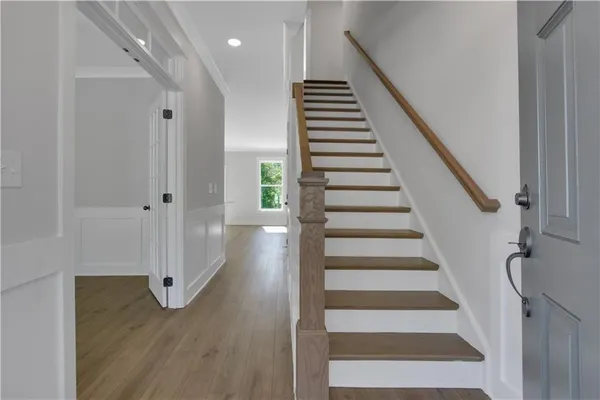 a view of entryway with wooden floor and stairs