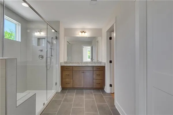 a bathroom with a shower a sink and a mirror