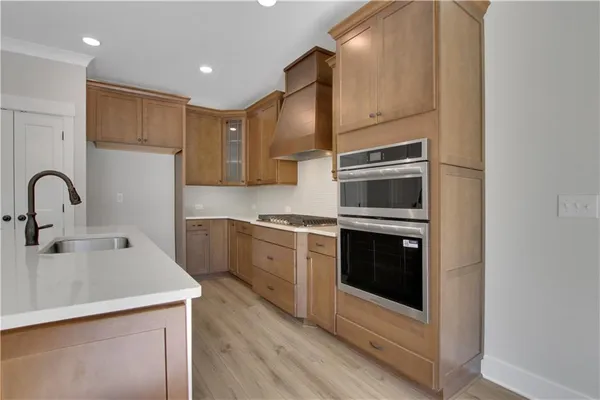 a kitchen with stainless steel appliances a stove sink and microwave