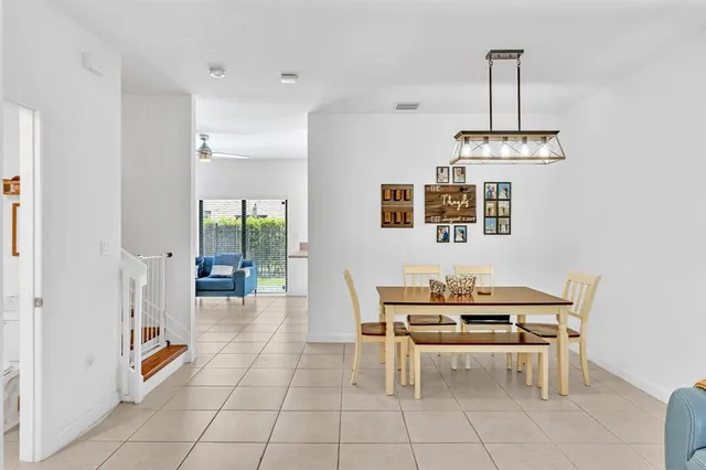 a view of a dining room with furniture and chandelier