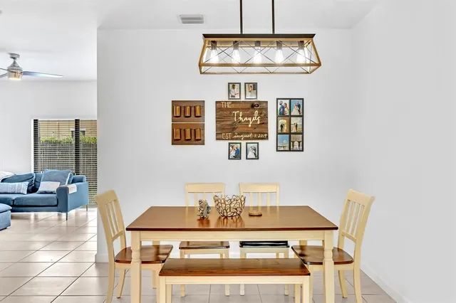 a view of a dining room with furniture and chandelier