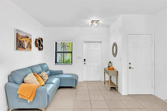 a view of a livingroom with furniture and floor to ceiling window
