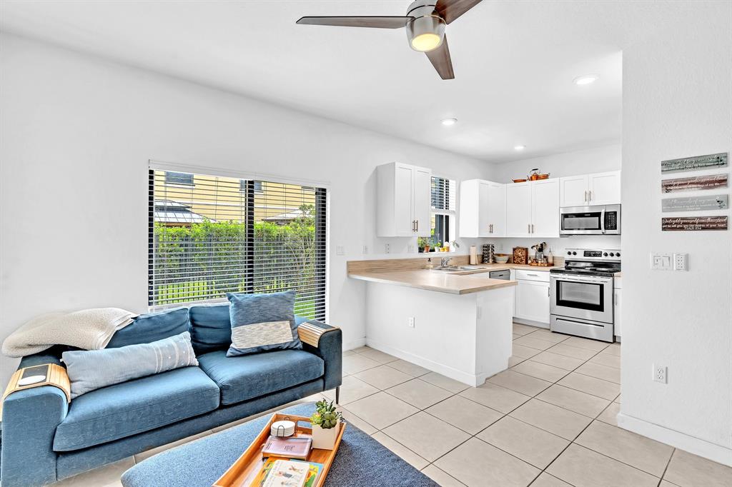 4668 Banker Terrace Davie, FL 33314 - Photo 22 of 52 a living room with stainless steel appliances granite countertop furniture a rug kitchen view and a window