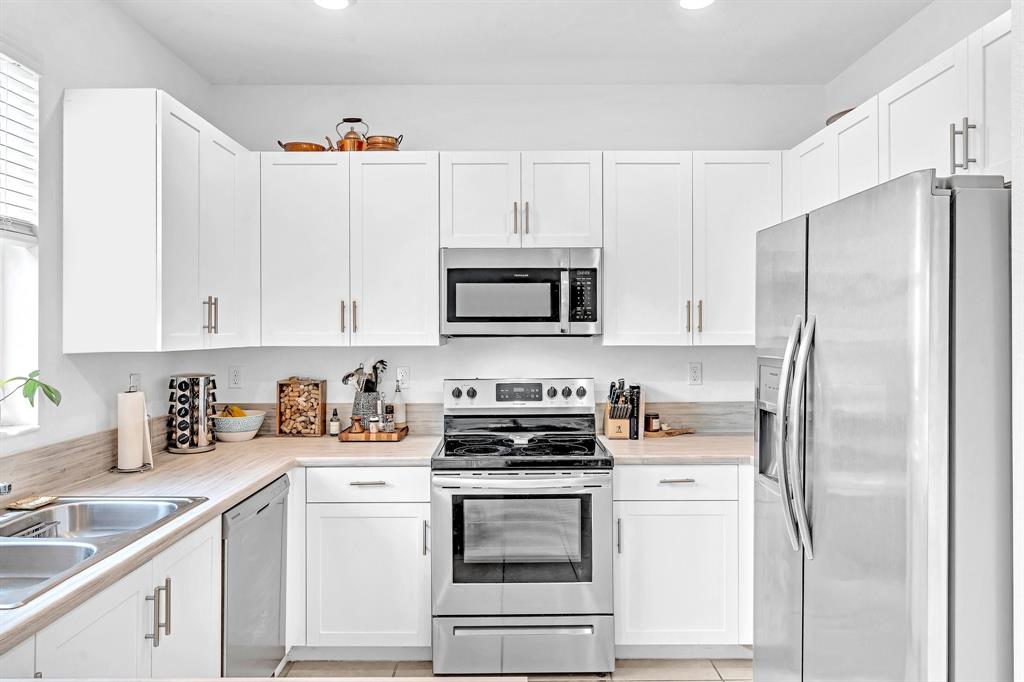 4668 Banker Terrace Davie, FL 33314 - Photo 25 of 52 a kitchen with cabinets stainless steel appliances and a sink