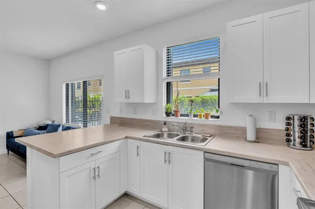 a kitchen with cabinets stainless steel appliances and a counter space