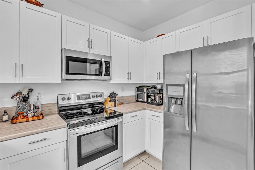 4668 Banker Terrace Davie, FL 33314 - Photo 28 of 52 a kitchen with cabinets stainless steel appliances and a counter space