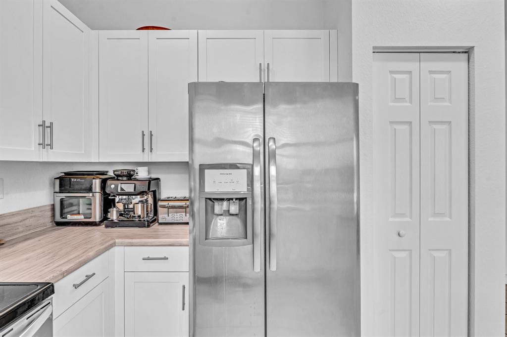 4668 Banker Terrace Davie, FL 33314 - Photo 29 of 52 a kitchen with a refrigerator and cabinets