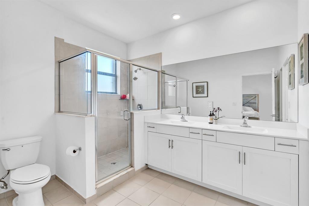 4668 Banker Terrace Davie, FL 33314 - Photo 38 of 52 a bathroom with a double vanity sink toilet and shower