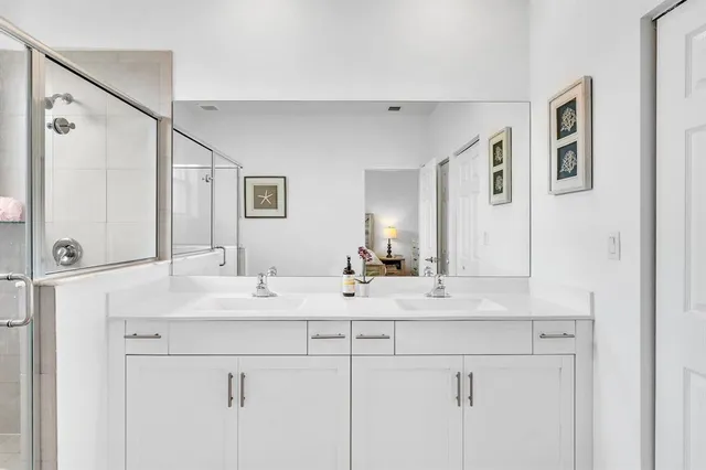 a bedroom with a bed a dresser and a window