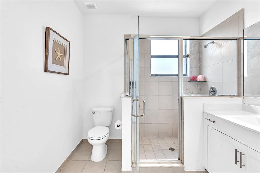 4668 Banker Terrace Davie, FL 33314 - Photo 40 of 52 a bathroom with a toilet sink a shower and a mirror