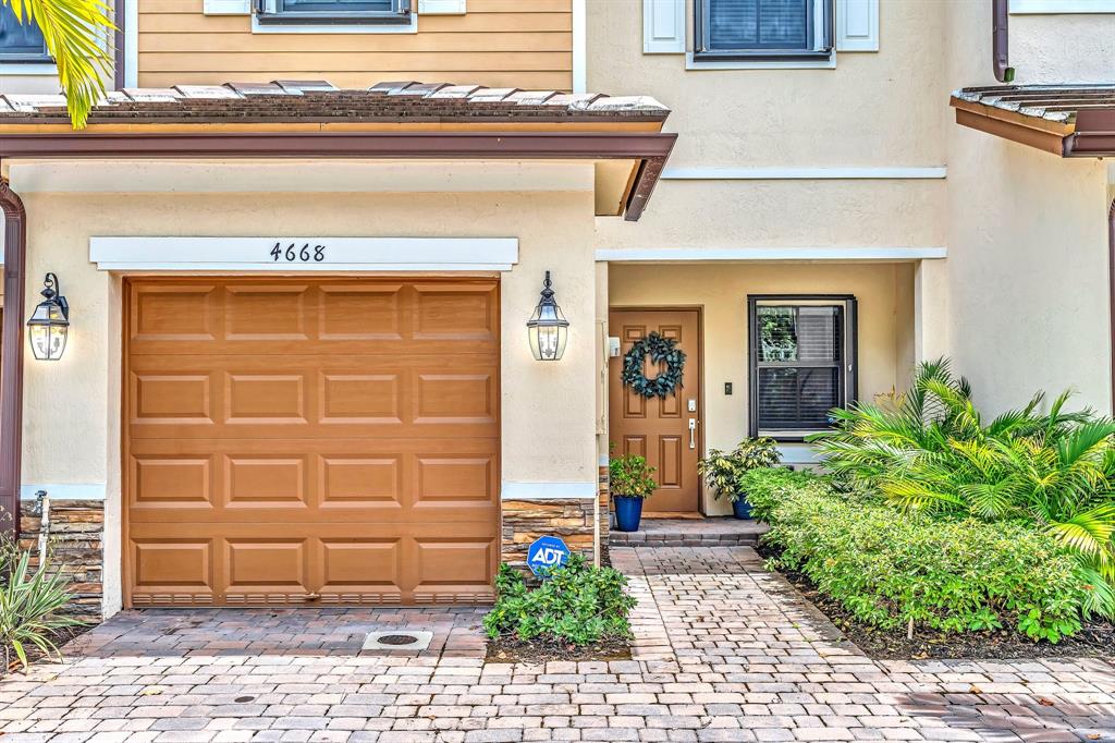 4668 Banker Terrace Davie, FL 33314 - Photo 4 of 52 a front view of a house with garden