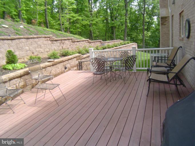 4908 Round Hill Road Frederick, MD 21702 - Photo 7 of 24 a balcony with wooden floor table and chairs