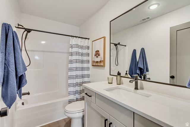 1389 1440 East, Unit 1 Payson, UT 84651 - Photo 15 of 17 Bathroom featuring a white bathtub and shower combination with a black shower rod, a white toilet, a light gray vanity with a single basin sink, and a large framed mirror