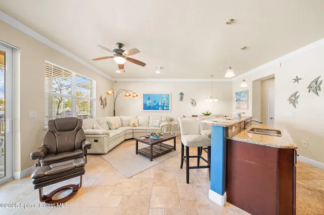 a living room with furniture a ceiling fan and a window