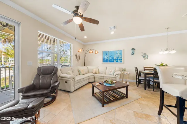 a living room with furniture ceiling fan and a window