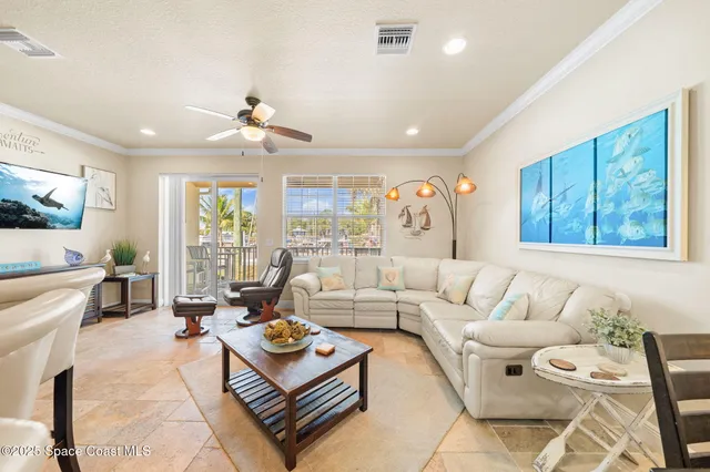 a living room with furniture a flat screen tv and a large window