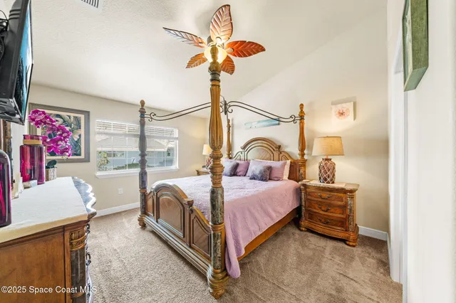 a bed room with a bed and a chandelier