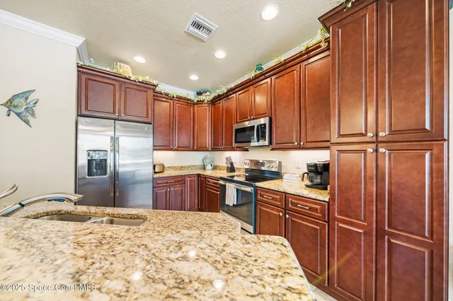 a kitchen with stainless steel appliances granite countertop a refrigerator sink and cabinets