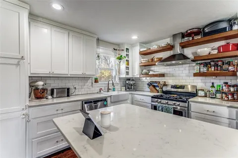 a kitchen with stainless steel appliances granite countertop a stove and a sink