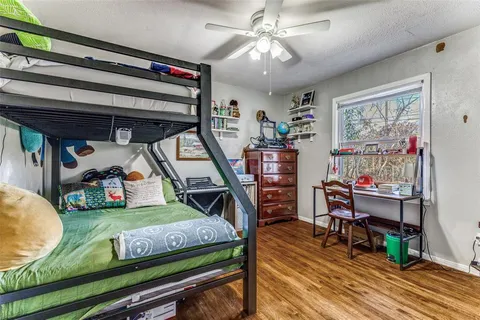 a living room with lots of furniture and paintings on the wall
