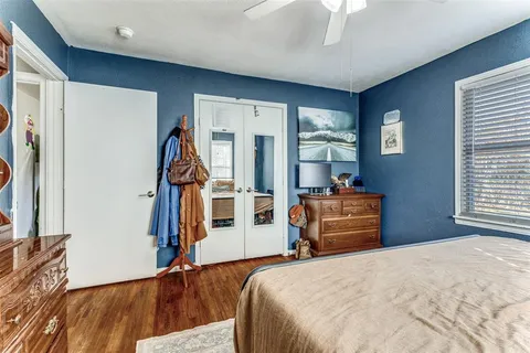 a bedroom with a bed and a large window