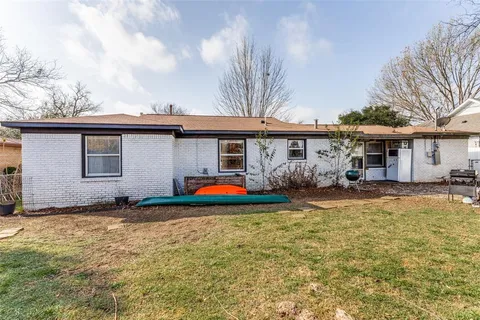 a view of a house with pool and a yard