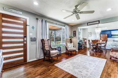 a living room with furniture and wooden floor