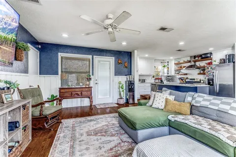 a living room with furniture and wooden floor