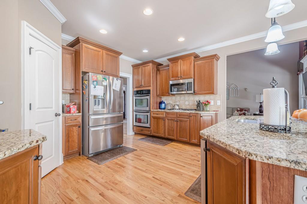 1765 Dew Place Southwest Marietta, GA 30064 - Photo 12 of 61 a kitchen with stainless steel appliances granite countertop a refrigerator and a stove top oven