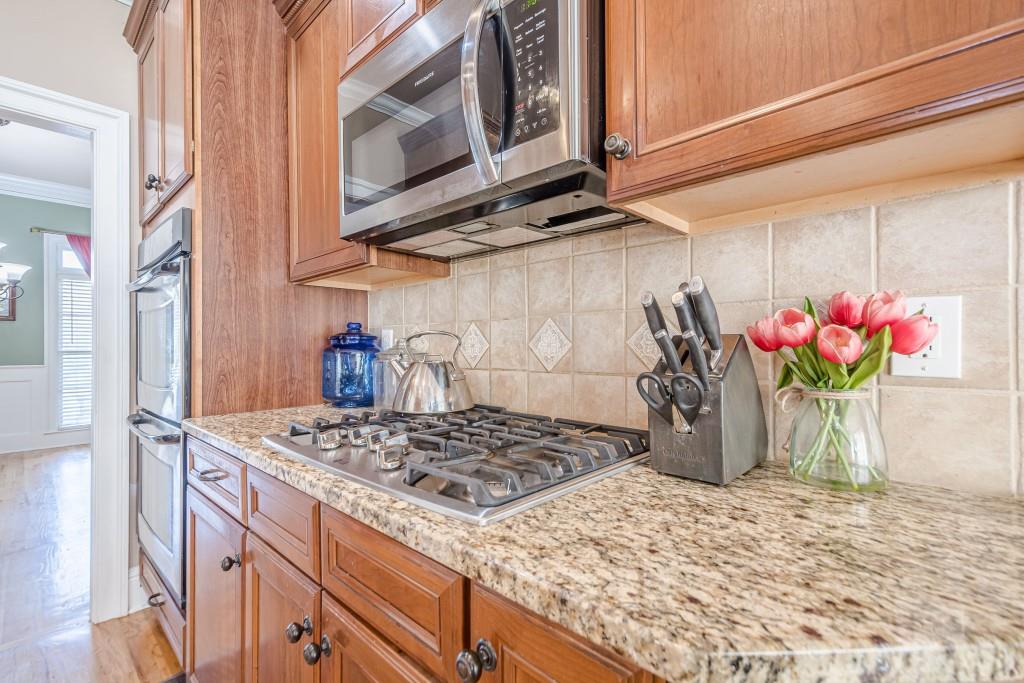 1765 Dew Place Southwest Marietta, GA 30064 - Photo 14 of 61 a kitchen with stainless steel appliances granite countertop a stove a microwave and cabinets