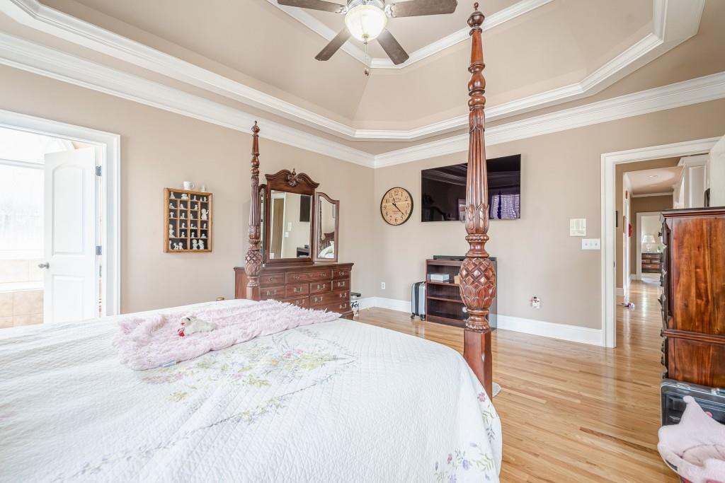 1765 Dew Place Southwest Marietta, GA 30064 - Photo 27 of 61 a bedroom with a bed and a flat tv screen on dresser