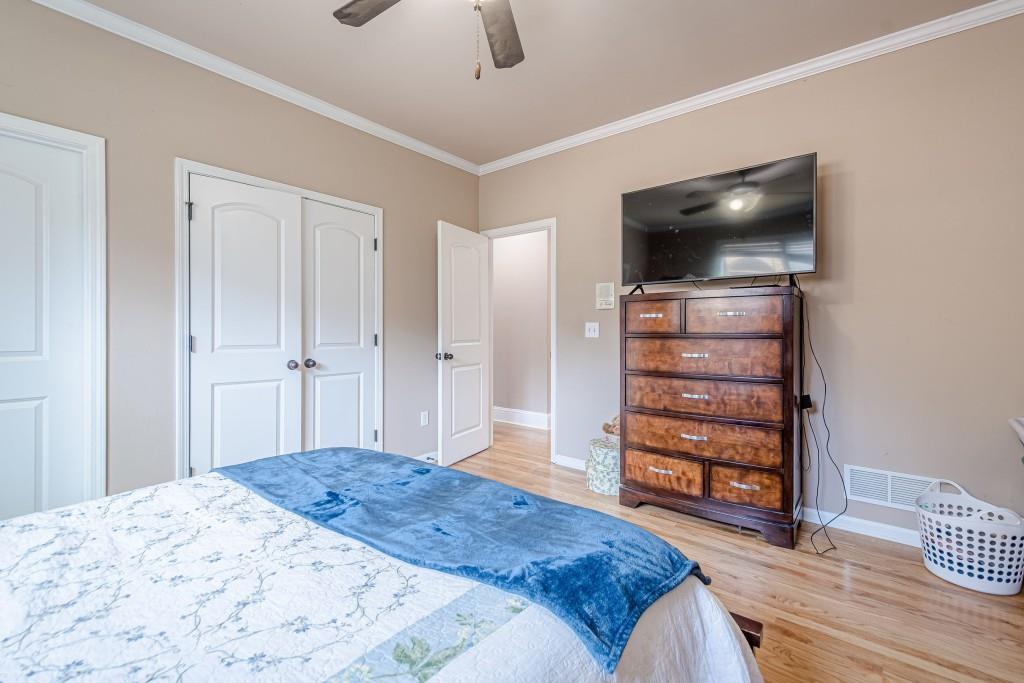 1765 Dew Place Southwest Marietta, GA 30064 - Photo 34 of 61 a bedroom with a bed and a flat screen tv