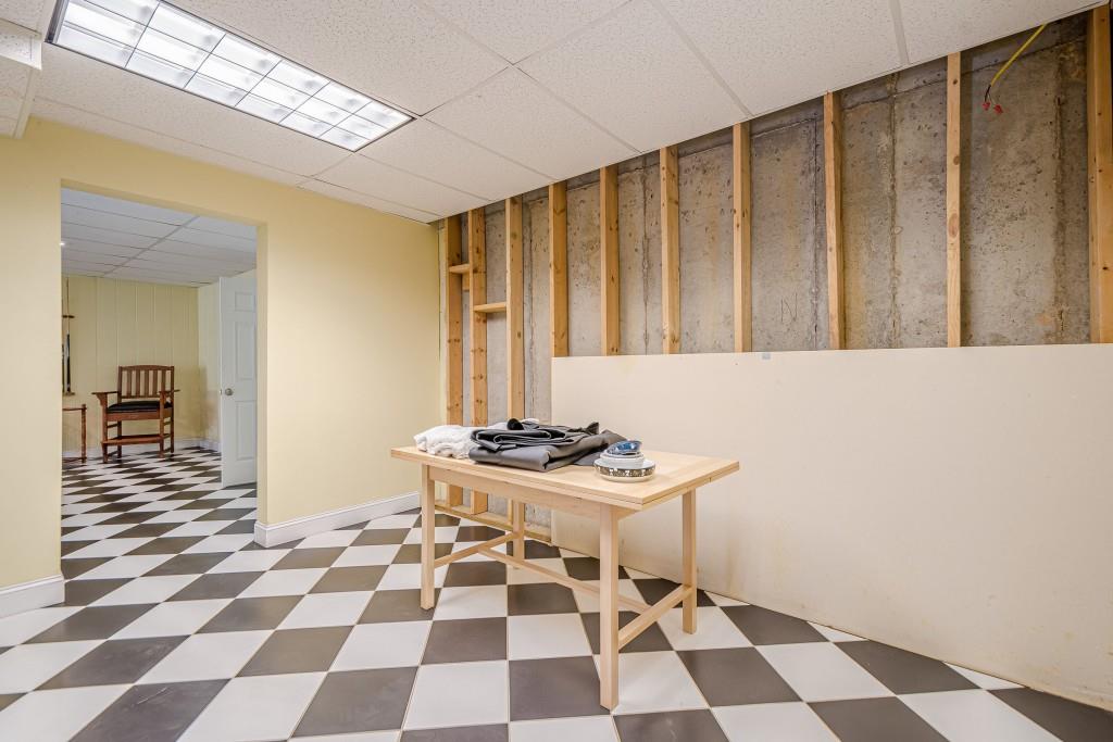 1765 Dew Place Southwest Marietta, GA 30064 - Photo 46 of 61 a room with a black white checkered floor with a gaming machine and a rug