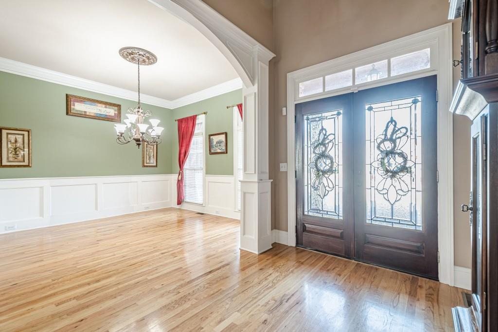 1765 Dew Place Southwest Marietta, GA 30064 - Photo 5 of 61 a view of an empty room with window and wooden floor