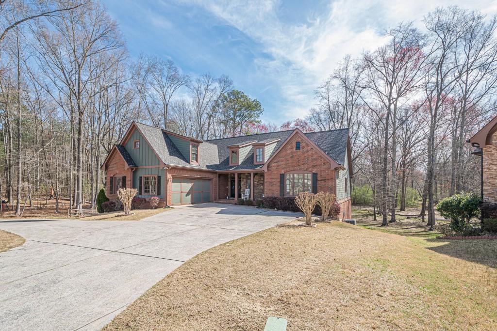 1765 Dew Place Southwest Marietta, GA 30064 - Photo 58 of 61 a front view of a house with a yard covered in snow