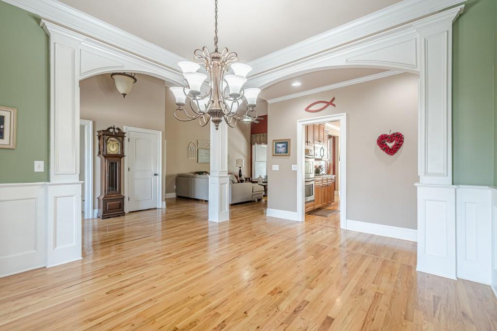 1765 Dew Place Southwest Marietta, GA 30064 - Photo 7 of 61 a view of a hallway with wooden floor and a chandelier