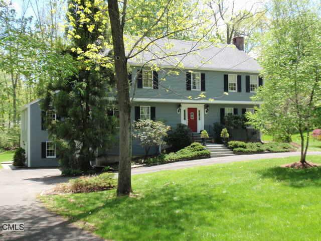 46 Woodlawn Drive Ridgefield, CT 06877 - Photo 1 of 1 a front view of a house with a yard and porch