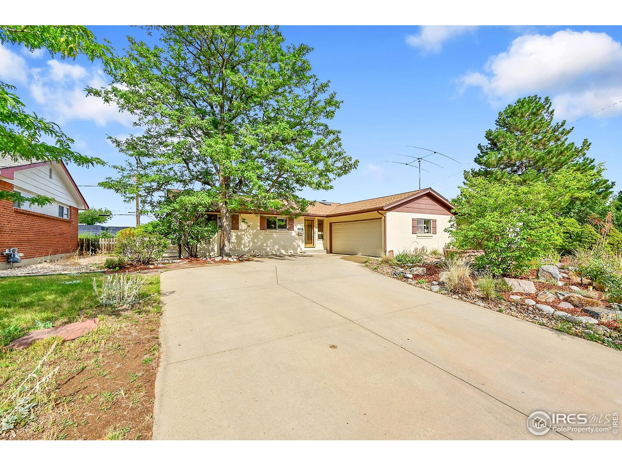 960 Toedtli Drive Boulder, CO 80305 - Photo 2 of 50 a front view of a house with a yard and a garage