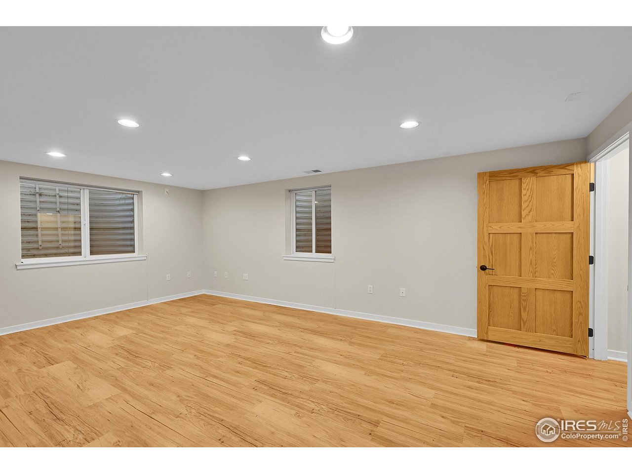 960 Toedtli Drive Boulder, CO 80305 - Photo 27 of 50 a view of an empty room with wooden floor and a window