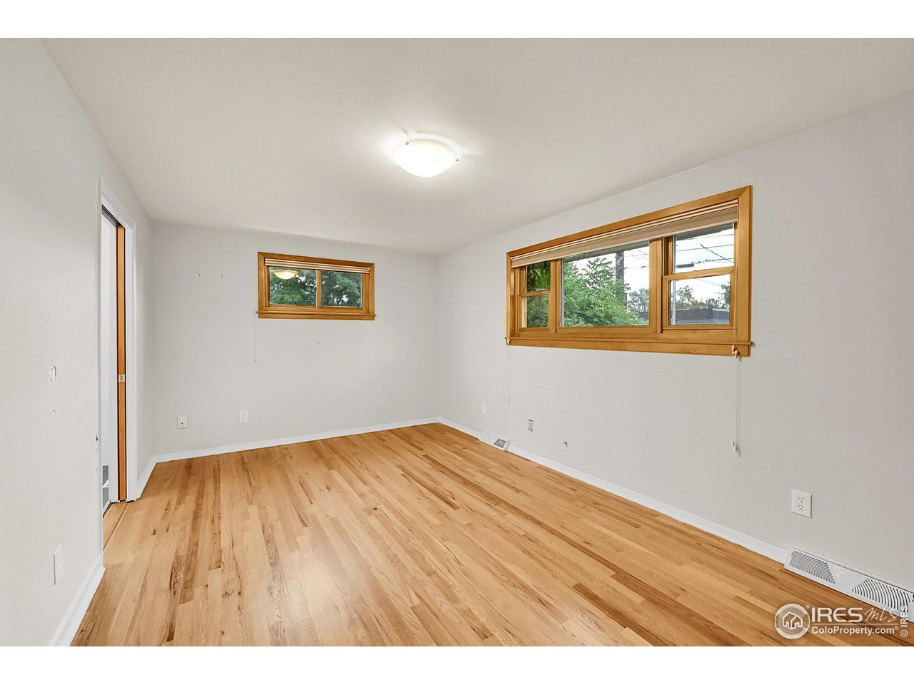 960 Toedtli Drive Boulder, CO 80305 - Photo 28 of 50 a view of an empty room with wooden floor and a window
