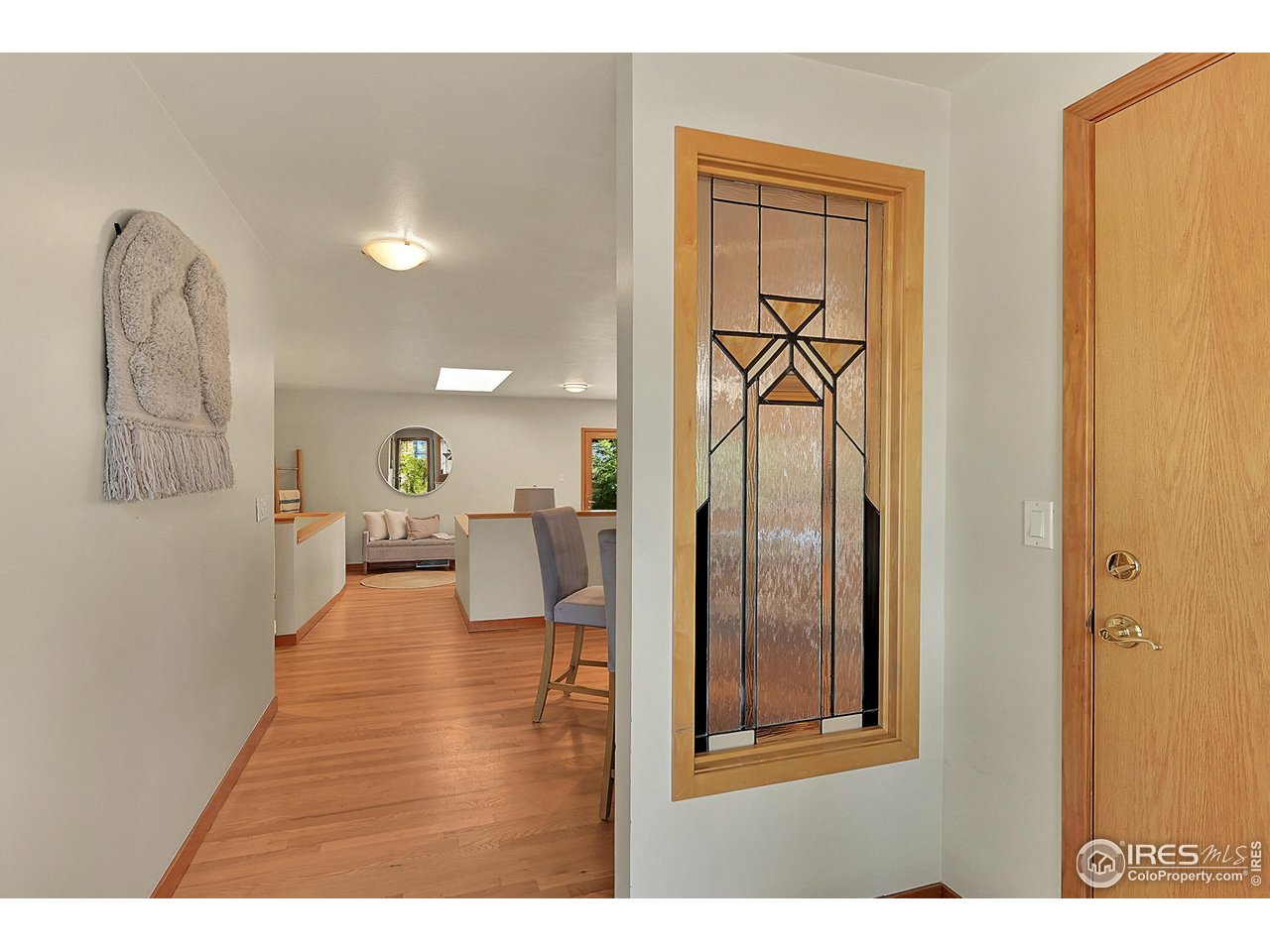 960 Toedtli Drive Boulder, CO 80305 - Photo 4 of 50 a view of a hallway with wooden floor and dining room