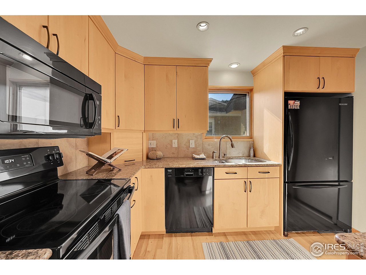 960 Toedtli Drive Boulder, CO 80305 - Photo 10 of 50 a kitchen with stainless steel appliances a sink stove and refrigerator