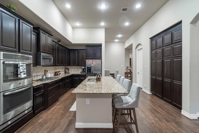 a kitchen with granite countertop stainless steel appliances and cabinets
