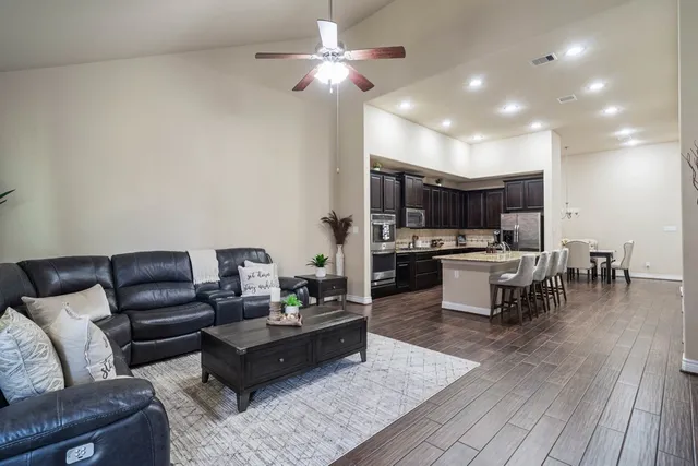 a spacious bedroom with a bed and a chandelier